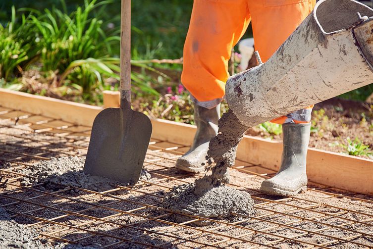 A builder laying concert foundations